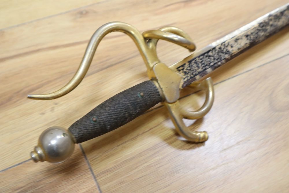 An officers sword with cast hilt and etched, 61cm double-edged blade